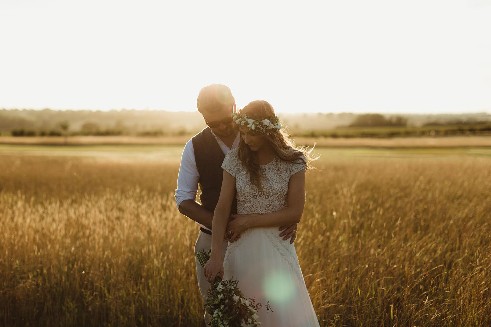 wedding portraits at sunset in field