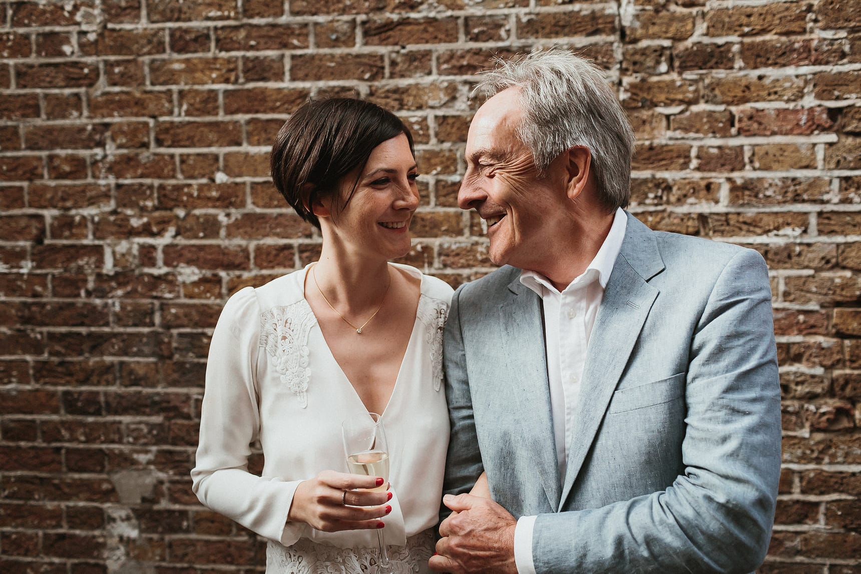 bride and father smiling while having photo taken