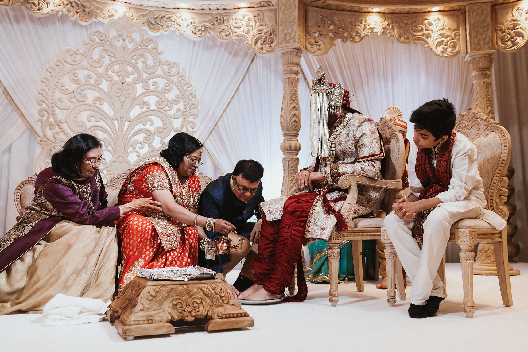 Mother and Father of the bride washing Grooms feet during a Hindu wedding ceremony