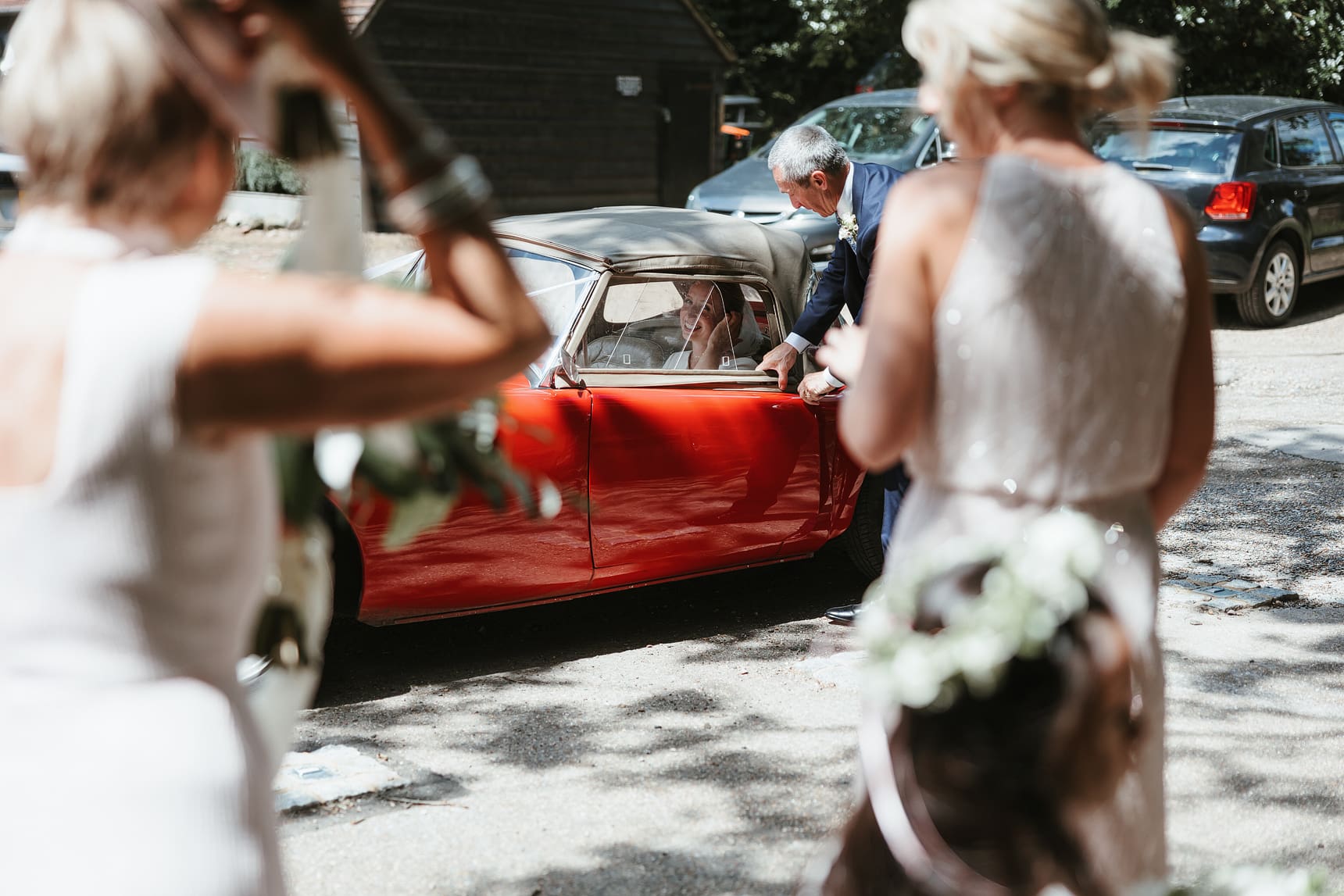 bride about to exit her wedding car