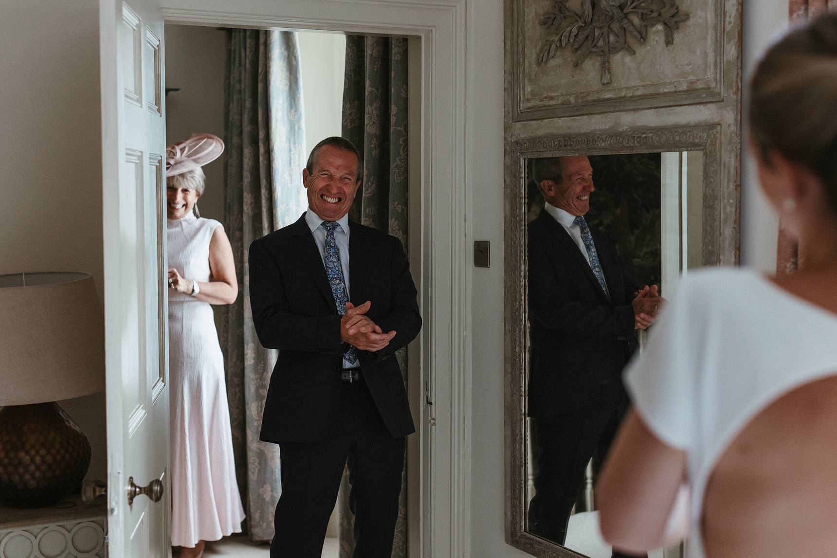 father of the bride seeing his daughter for the first time in her wedding dress