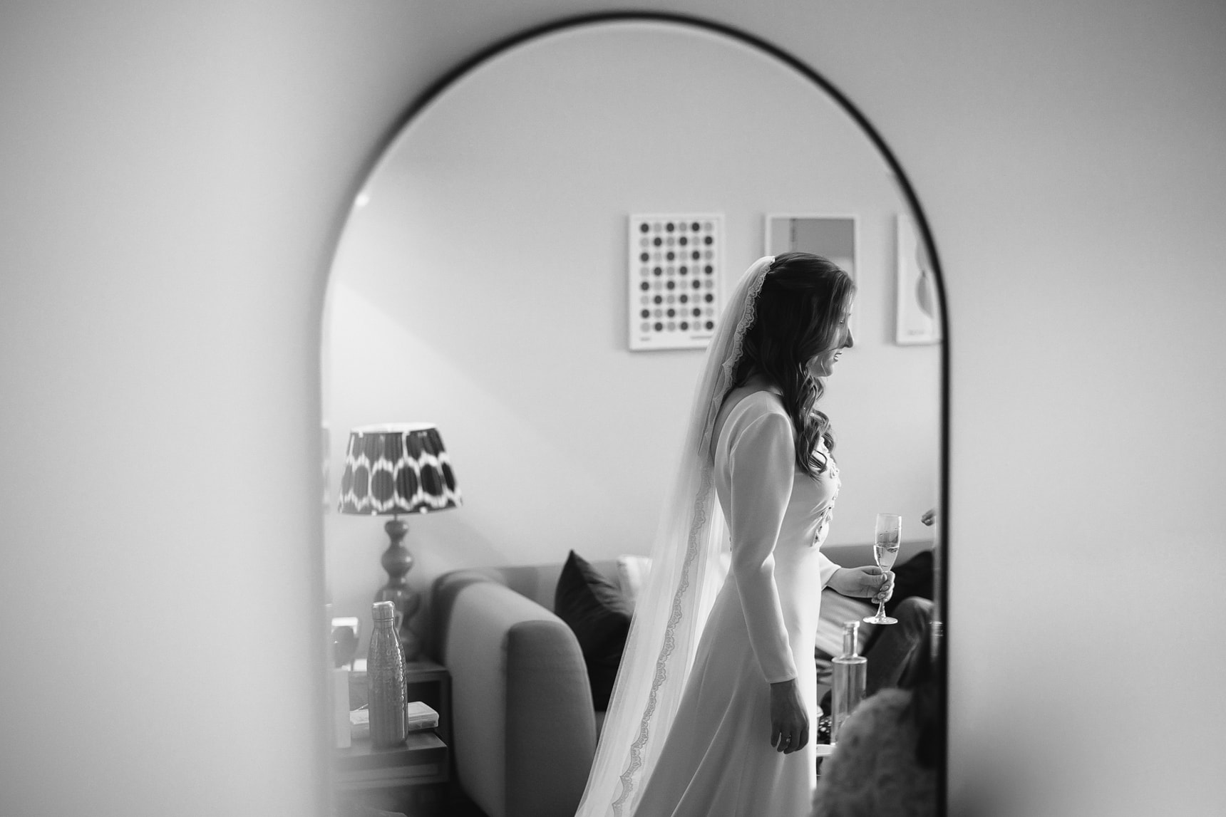 Black and white reflection photo of a bride in the morning