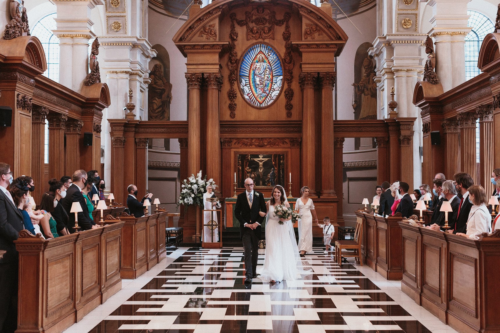 Bride and groom walking down the aisle in a large church in London