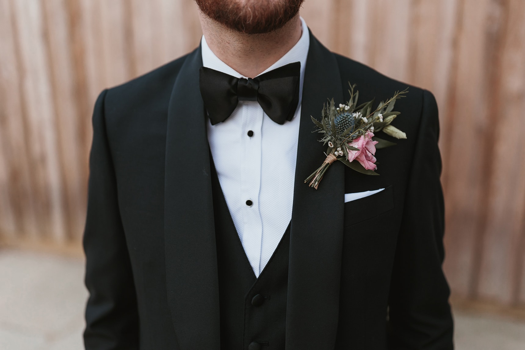 Detailed shot of the grooms Tuxedo and buttonhole
