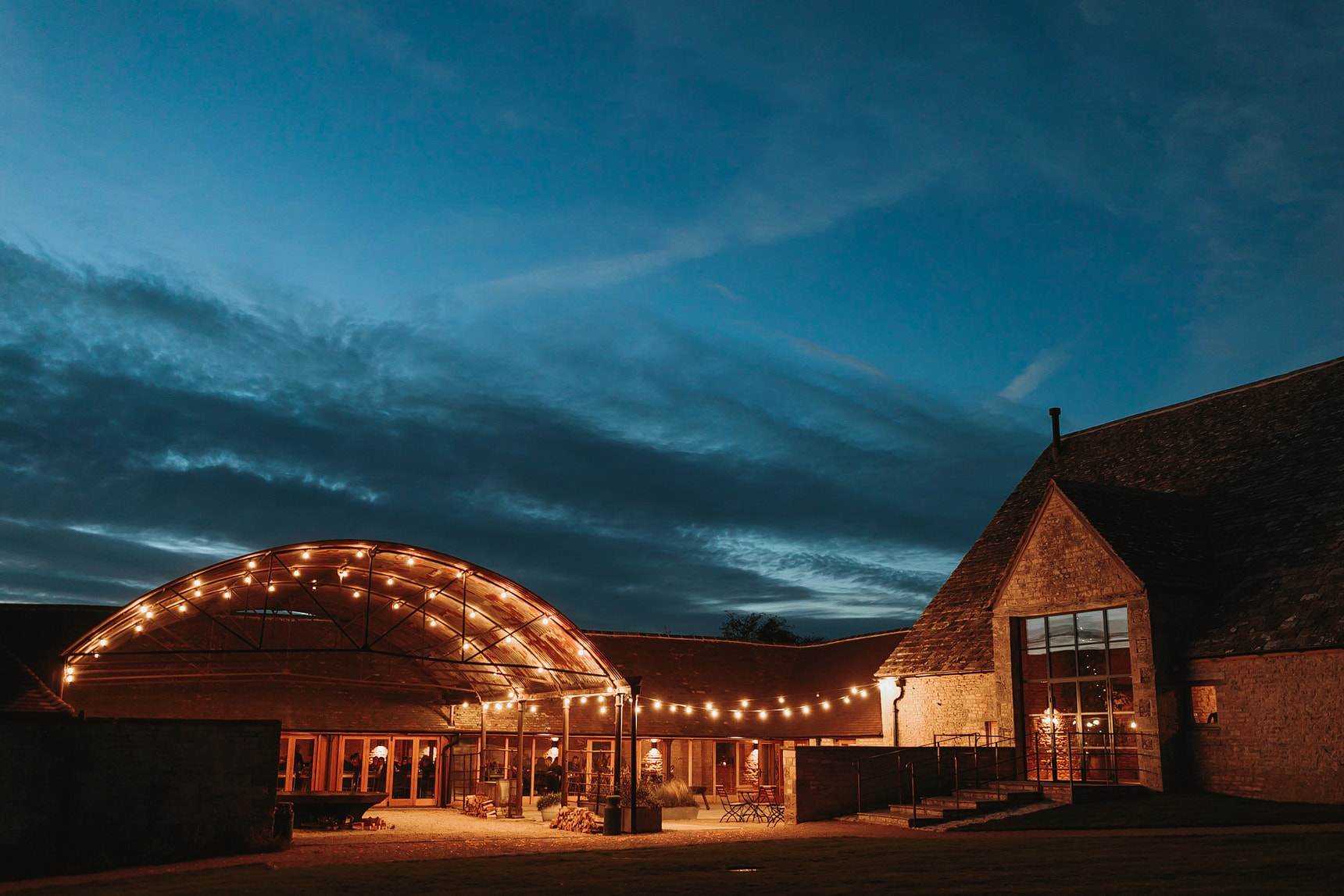 Evening photograph of a wedding venue with festoon lighting