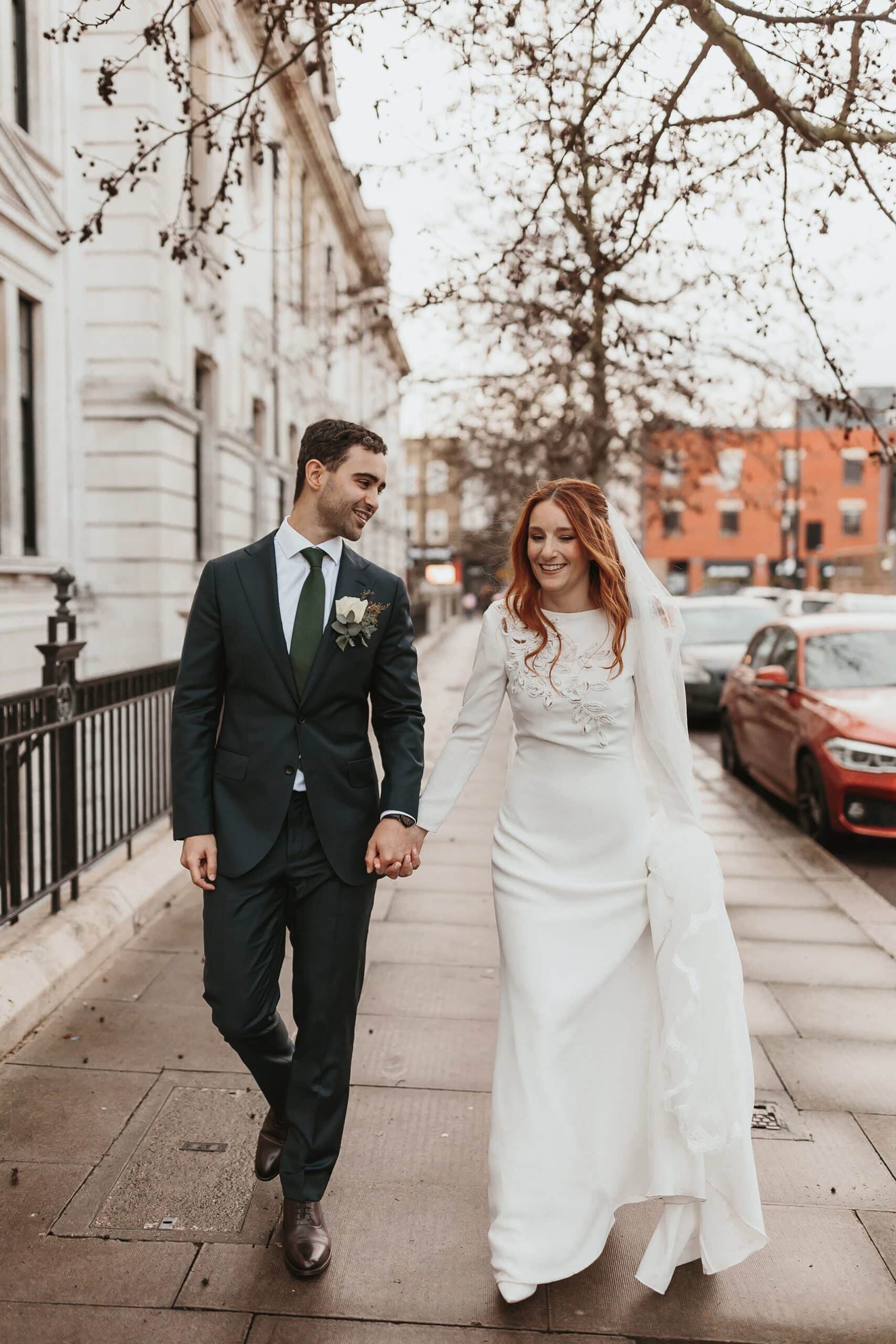 Portrait of a bride and groom walking down the streets of London